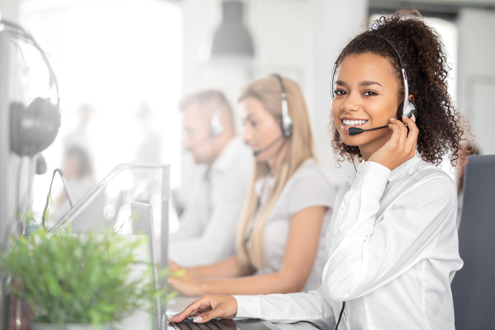 Woman smiling at camera with headset on